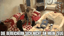 a woman is laying on a bed next to a table with a box of medicine on it .