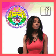a woman is sitting in front of a logo for persib