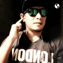 a man wearing sunglasses and a t-shirt that says ' woohoo ' on it