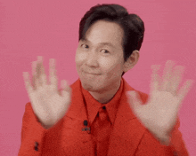 a man in a red suit is making a funny face