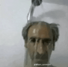 a man with a shower head on his head