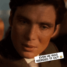 a close up of a man 's face with a sticker that says " even he was weirded tf out " on it