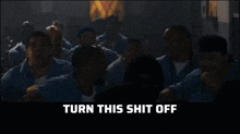 a group of men are standing in a dark room with the words turn this shit off on the bottom