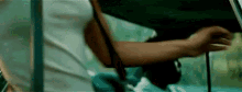 a close up of a person 's hand holding a piece of paper in a car .