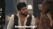 a man and a woman are having an argument and the man is saying " achaar daalege "