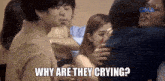 a group of people are hugging each other with the caption " why are they crying "