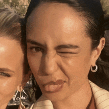 a close up of a woman making a face with her tongue out