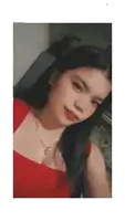 a woman wearing a red top and a necklace with a heart shaped pendant