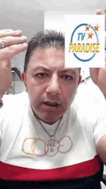a man in a white shirt holds up a sign that says tv paradise