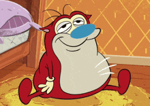 a cartoon character with a blue nose is sitting on a rug