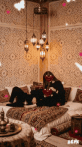 a woman laying on a bed with a red heart in front of her face ..