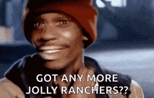 a man in a red beanie is smiling and asking if he has any more jolly ranchers .