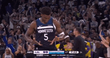 a basketball player for the minnesota timberwolves celebrates with the crowd