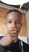 a young man wearing ear buds covering his mouth