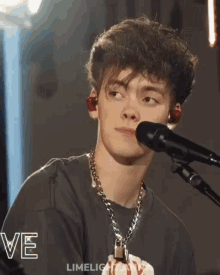 a young man singing into a microphone with the word limelight on the bottom left