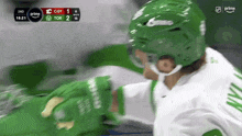 a hockey player wearing a green helmet and gloves during a game on prime
