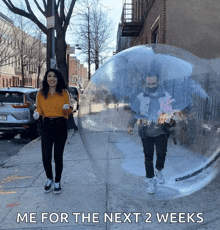 a man and a woman are walking in a clear bubble with the words me for the next 2 weeks below them