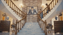 a staircase with a picture of a man in a suit on it