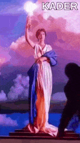 a statue of a woman holding a light with the word kader written on the bottom