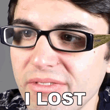 a man wearing glasses says i lost