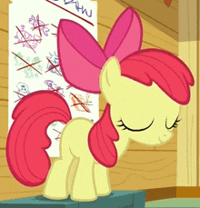 a cartoon pony with a pink bow on its head is standing in front of a wall with drawings on it