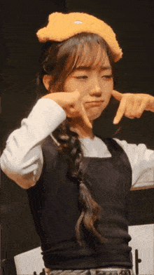 a woman wearing a teddy bear headband is making a face