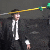a man in a suit and tie is being filmed by a camera