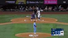 a baseball game is being played in front of a banner for globe life field