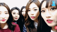 a group of girls are standing next to each other and one of them has a peace sign on her face .