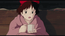 a girl with a red bow on her head is holding a mug