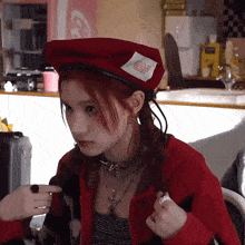 a woman wearing a red beret has a label on her hat that says coca cola