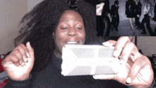 a woman is taking a picture of a group of people