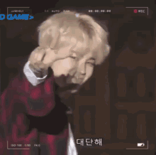 a man is making a funny face in front of a camera that says ' o game > ' on it