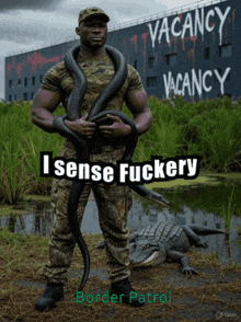a man holding a snake in front of a building that says vacancy vacancy