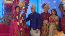 a bride and groom are posing for a picture with their family at a wedding
