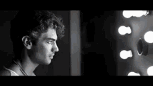a man is looking at himself in a mirror .
