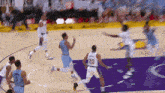 a basketball game is being played on a court with the number 20 on the back of a player 's jersey