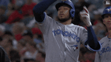 toronto blue jays baseball player wearing a white jersey