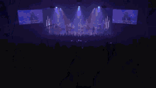 a person playing drums in a dark room with a cymbal in the background