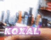 a blurred image of a shelf with the word koxal on it