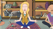 a woman sits in a lotus position in front of a book titled omg the magic