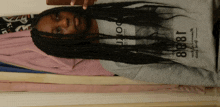 a woman with braids is wearing a sweatshirt that says 1888 on it