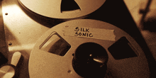 a tape recorder with a label that says silk sonic on it