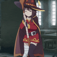 a girl in a witch costume is holding a broom with an x on it