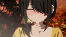 a girl in a yellow shirt is crying with a tear running down her cheek