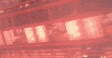 a flying dragon is flying over a building with red lights on it .