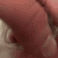 a close up of a person 's hand on a white surface with a red background .