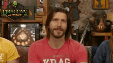 a man is wearing a red shirt that says krac on it