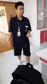 a man wearing a lanyard with a name tag that says ' a ' on it