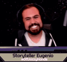 a man with a beard is smiling in front of a microphone with the name storyteller eugenio on the bottom